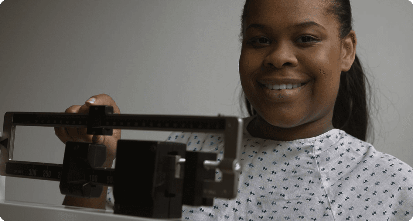 Woman in a medical gown smiling